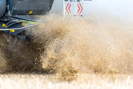 Close view on the harvester working on the fieldの写真素材