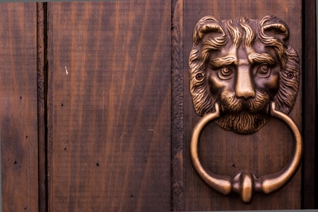 Bronze kind lion door knocker the chinese traditional on wooden door - door knocker in shape of lion headの写真素材