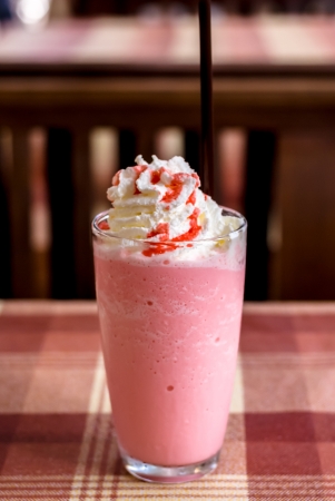 sweet strawberry milkshake and frappe - iced and milk blended with whiping creamsの写真素材