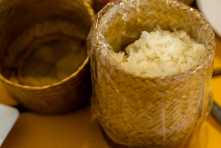 asian sticky rice in a bamboo wooden old style box - Thai sticky rice in a small basket made of bambooの写真素材