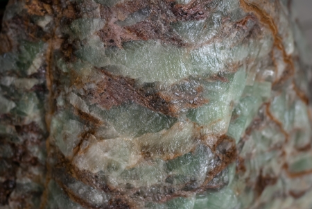 closeup roughness green stone texture with orange and brown lines like a emeraldの写真素材