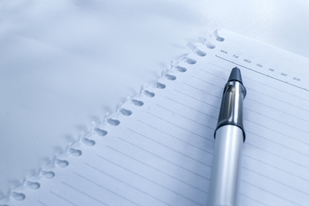 Blank notebook with date and day - White paper texture background - Ballpoint pen on checked notebook paperの写真素材