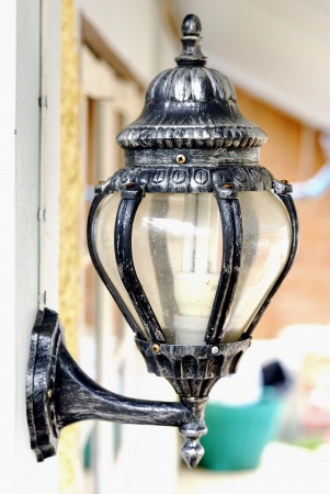 Old traditional wall mount lamp - Ornamental wrought iron lantern - Street black lanternの写真素材