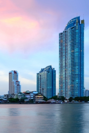 Glass wall of modern office buildings in twilight the across riverの写真素材