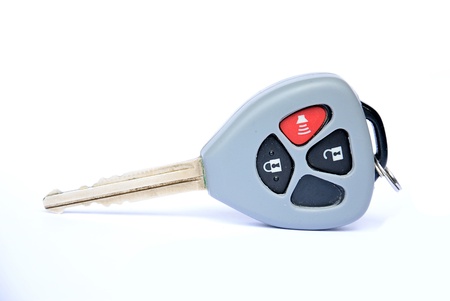 Car key with remote buttons on white background - Car ignition key with remote controlの写真素材