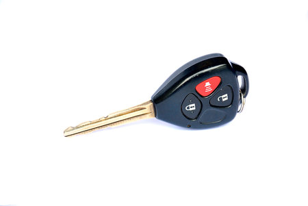Car key with remote buttons on white background - Car ignition key with remote controlの写真素材
