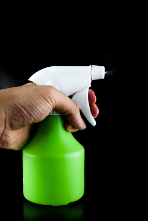 Green plastic sprayer isolated on black backgroundの写真素材