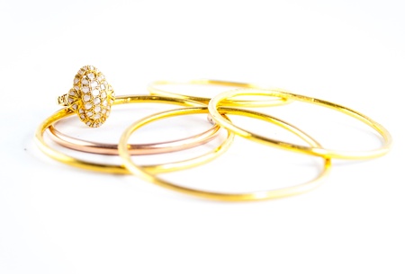 Jewellery ring and golden bracelet on white backgroundの写真素材