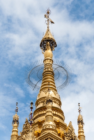 Top of yellow pagoda against blue clear skyの写真素材