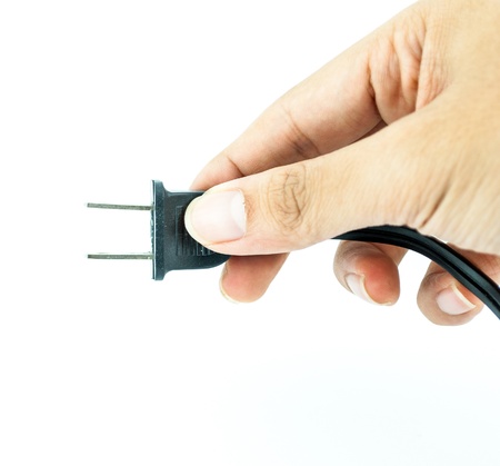Electric plug with hand - power plug - Black electric cable isolated on whiteの写真素材