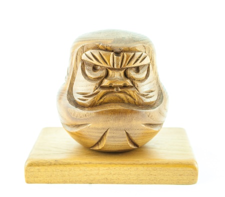 angry wooden doll on the wooden plate - wooden doll on a white backgroundの写真素材