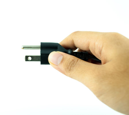 Electric plug with hand - power plug - Black electric cable isolated on white