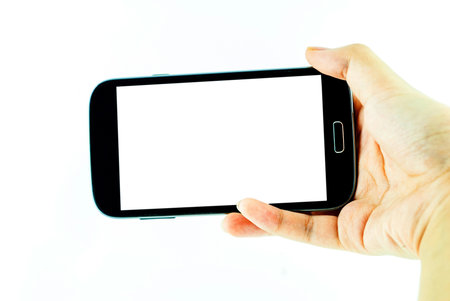 Cell phone with touchscreen in female hand on white background - female hand is holding a modern...