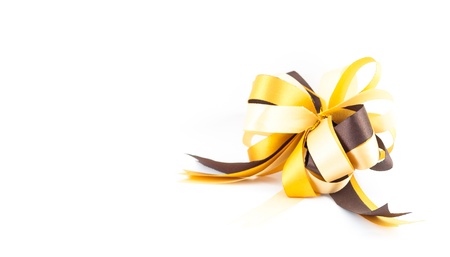 golden or yellow ribbon bow isolated on white backgroundの写真素材