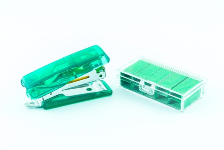 Green stapler and bunch of staples isolated on whiteの写真素材