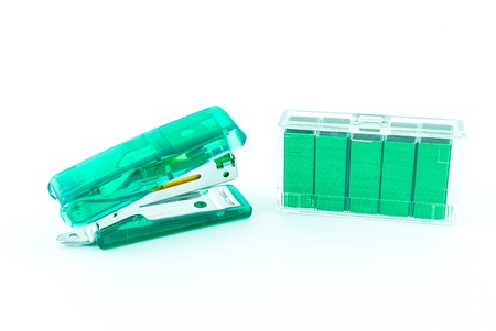 Green stapler and bunch of staples isolated on whiteの写真素材