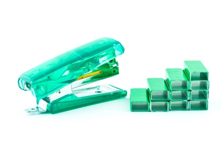 Green stapler and bunch of staples isolated on whiteの写真素材