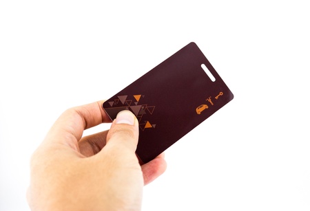 Hand Holding Up Security Clearance key Card isolated on whiteの写真素材