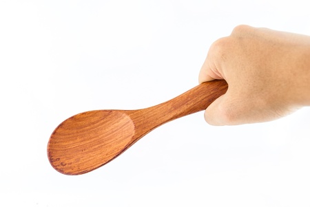 Wooden Spoon in hand Isolated on a white backgroundの写真素材