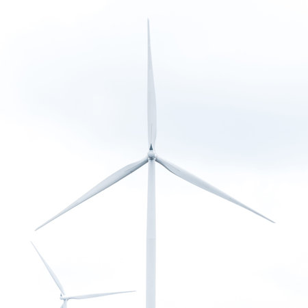 wind turbine in wind farm against cloudy sky