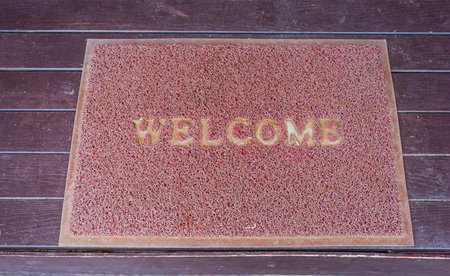 Used welcome carpet mat, welcome doormat carpet on the floorの写真素材