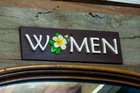 woman symbol sign in front of toilet の写真素材