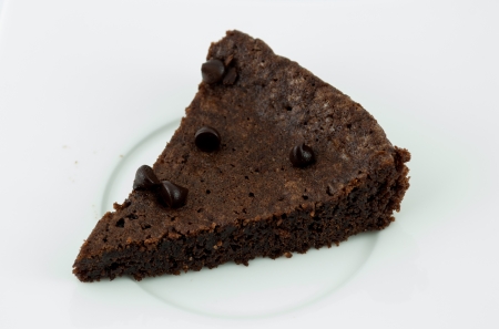 A piece of dark chocolate Cake and chocolate chip on plateの写真素材