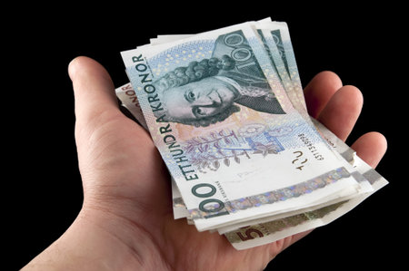 Human hand holding swedish money / Swedish currency の写真素材