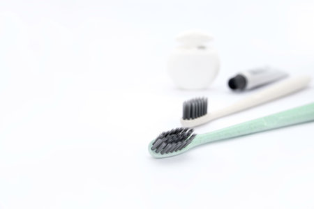 Toothbrushes and toothpaste on white background with copy spaceの写真素材