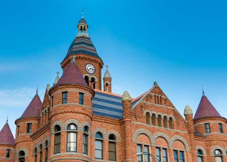 Medieval red stone castle with blue roof against white cloudy skyのeditorial素材