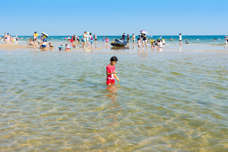 Chinese kid swimming at the Hailing island of Yangjiang during the long holiday of China National Day.のeditorial素材