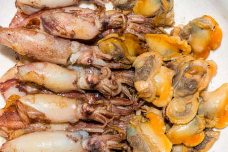 Chinese food -closed-up of fried squids and clam meat on dishの写真素材