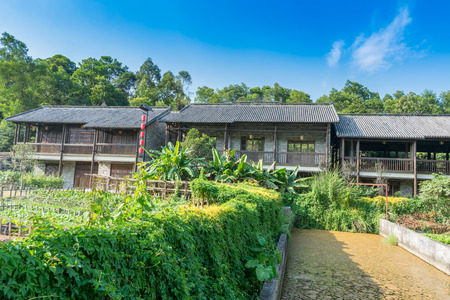 A typical Chinese wooden Hakka's house with vegetable garden in Shenzhen, China.のeditorial素材