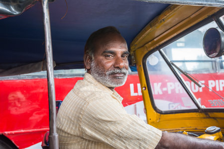Hyderabad, Andhra, India- November 18, 2016: Portrait of Indian Tuktuk driver at the street of...