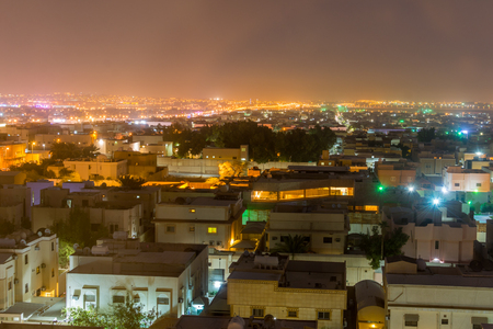 Aerial night view with neon light of Riyadh with buildings and rooftopsの写真素材