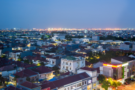 Aerial view of Jakarta's downtown, with residential houses rooftops and tall buildingsのeditorial素材