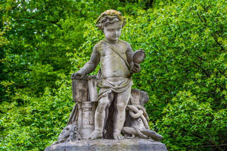 The sculpture of a boy looking at a mirror on the wall of Royal Palace in Brusselsのeditorial素材