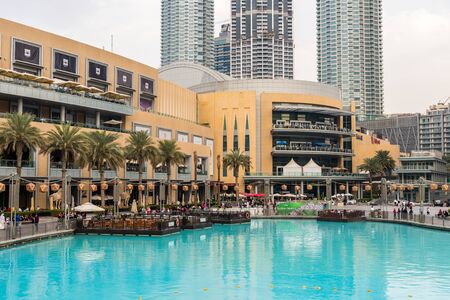 The dancing fountain and The Dubai Mall, the worlds largest destination for shopping, entertainment and leisure located next to the world's tallest building, the Burj Khalifa.のeditorial素材