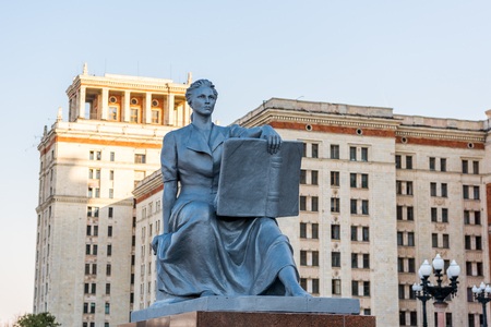 A statue of a female student with a book next to the entrance to the main building of Moscow State University, MSU. Named after Lomonosov in Moscow, Russia.のeditorial素材