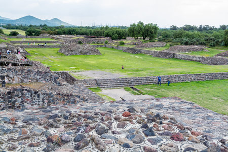 Ruins of walls and foundation of the architecturally significant Mesoamerican pyramids and green...