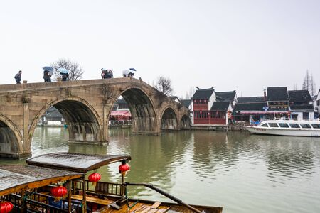 Stone bridge and old buildings in Zhujiajiao, an ancient water town in Shanghai, best known for its bridges, built during Ming and Qing Dynasties, the various spans are built of wood, marble and stone.のeditorial素材