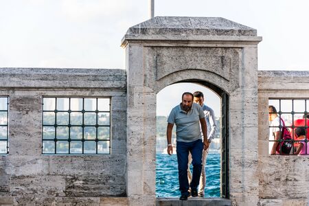 Musilim man walking into the Semsi Pasa Mosque Complex under sunset at the  at Uskudar, Istanbul, Turkey, on the Anatolian shore of the Bosphorus.のeditorial素材