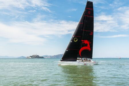 A black yacht ship sailing at the Fisherman's Wharf Pier 39 marina in San Francisco, California, USAのeditorial素材