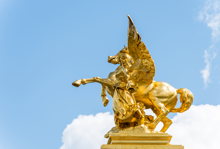 Golden pegasus statue at the Pont Alexander III bridge, Paris, a deck arch bridge that spans the Seine in Paris, Franceのeditorial素材
