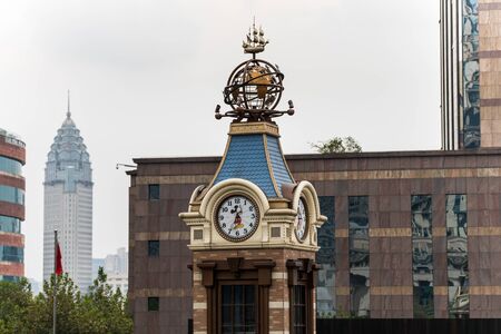 Statue of globe and ship on the top of a clcok tower in Shanghai, China.のeditorial素材