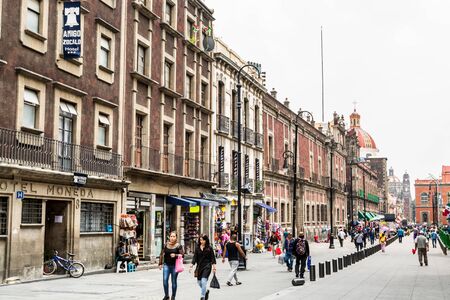 Street view of shopping street with historic buildings near the main plaza in the downtown of Mexico City.のeditorial素材