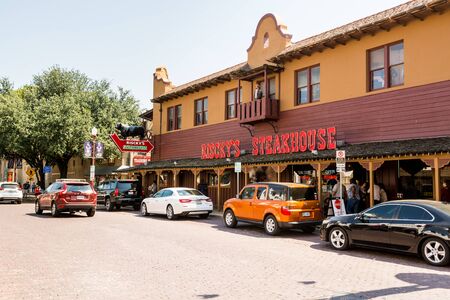 Street view with restaurants at the Fort Worth Stockyards, a historic district that is located in Fort Worth, Texas, USA.のeditorial素材