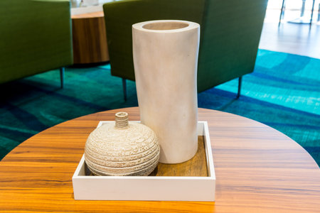 Two beautiful bottle and porcelain vase on a wooden table for interiors decoration.の写真素材