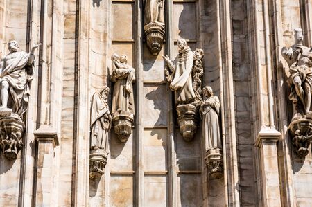 Architectural details with statues on the wall of beautiful building of the Milan Cathedral (Duomo di Milano), the cathedral church of Milan, Lombardy, Italy. Dedicated to the Nativity of St Mary.の写真素材