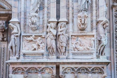 Architectural details with statues on the wall of beautiful building of the Milan Cathedral (Duomo di Milano), the cathedral church of Milan, Lombardy, Italy. Dedicated to the Nativity of St Mary.の写真素材